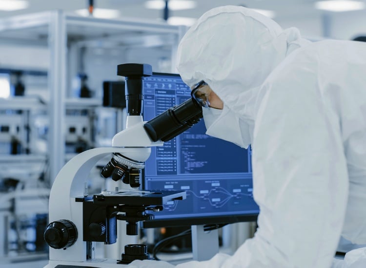 Laboratyory testing services. Consulting Services. Scientist in a laboratory looking through a microscope and personal computer. Modern manufactured semiconductors and pharmaceuticals