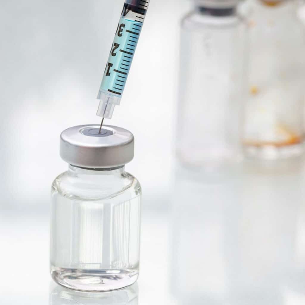 Vial being filled with a syringe. Sustained-release injectables drug delivery. Parenteral products. Why sustained-release injectables are preferred.