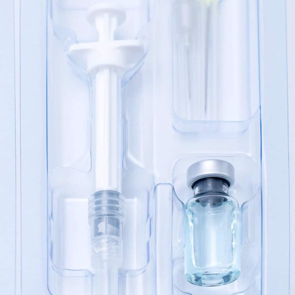 Close picture of packaged flasks and syringes. Fluid and gas leaks. What is vacuum leak test. Why is vacuum leak test important. How is vacuum leak test performed.