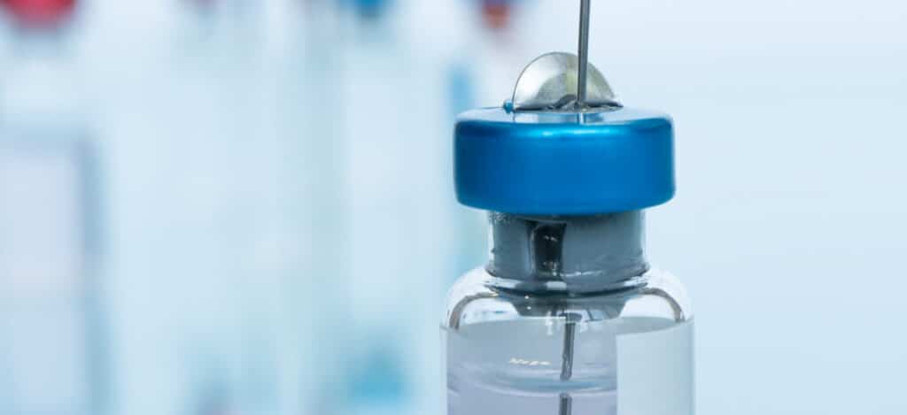 Close picture of syringe inside of a vial. Functionality testing for plastics. Testing for plastics used in injectables. Elastomeric packaging used in injectables. Plastic suitability for medical product packaging. Procedure for functionality testing. Acceptance criteria of functionaility testing