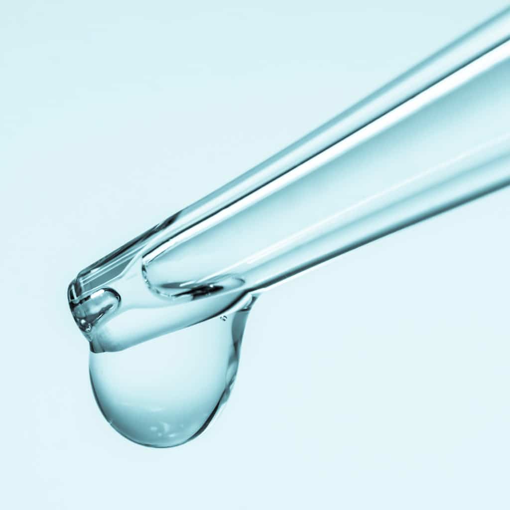 Close picture of a pipette dropping water. Microbiology vs microbial immersion challenge testing. Differences between microbiology and microbial immersion challenge testing. What products require microbial immersion challenge testing. Microbiology testing for cosmetic products. Microbial immersion challenge testing for cosmetic products. Microbiology testing for parenteral products. Microbial immersion challenge testing for parenteral products