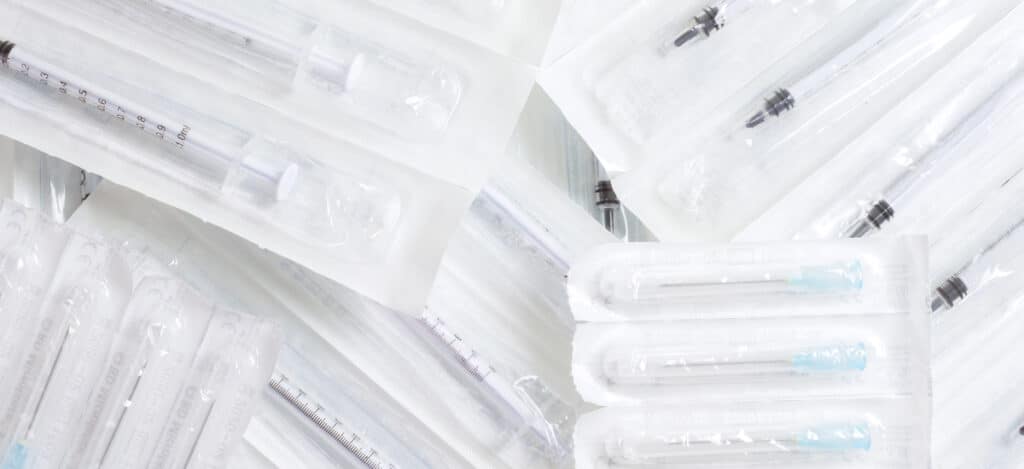 Picture of various syringes and needles in an sterile packaging. Seal quality tests for sterile packaging. Seal quality tests. What are seal quality tests. What are leak tests. Package seal quality characterization and monitoring. Five tests to determine seal quality