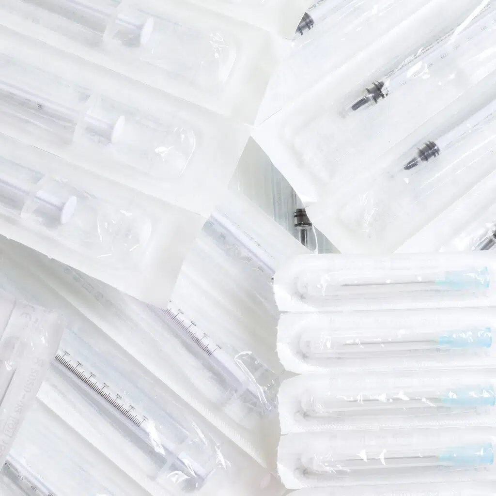 Picture of various syringes and needles in an sterile packaging. Seal quality tests for sterile packaging. Seal quality tests. What are seal quality tests. What are leak tests. Package seal quality characterization and monitoring. Five tests to determine seal quality