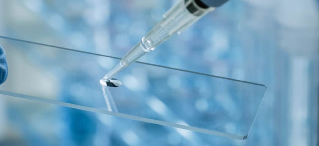 Close picture of a micro pipette dropping a sample. Zone of inhibition testing. Zone of inhibition. Usp 81 zone of inhibition testing. Usp 81 zone of inhibition. Antimicrobial medical products. Antimicrobial testing. Cylinder-plate assay. Cylinder-plate method. Usp 81 cylinder-plate test. Usp 81 plate test